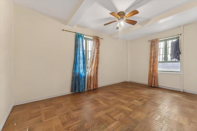 unfurnished room with baseboards, a ceiling fan, and a healthy amount of sunlight