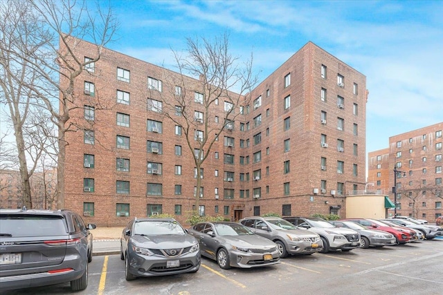 view of building exterior featuring uncovered parking