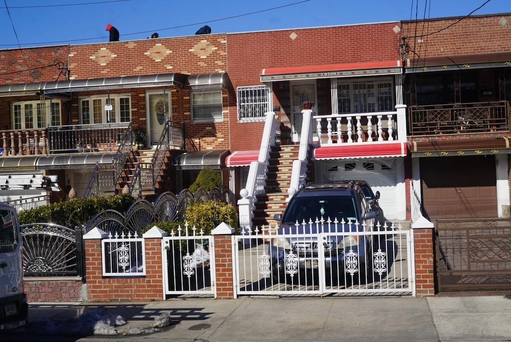 view of property featuring a fenced front yard and concrete driveway