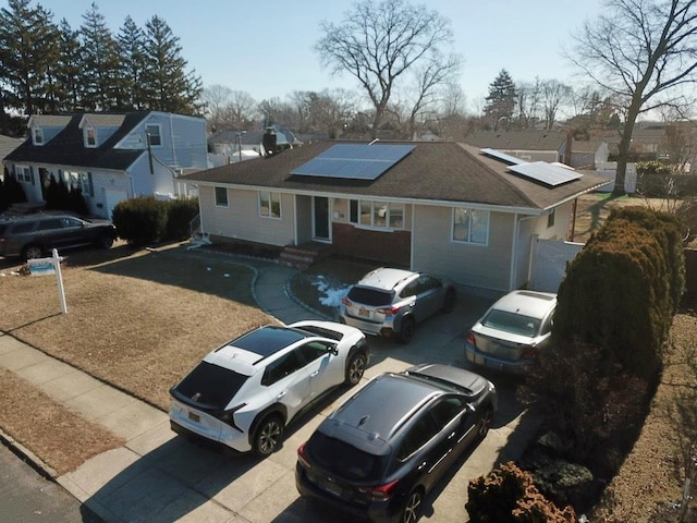 view of front of home featuring solar panels and a residential view