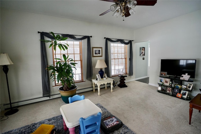 sitting room featuring ceiling fan, carpet floors, and a baseboard heating unit