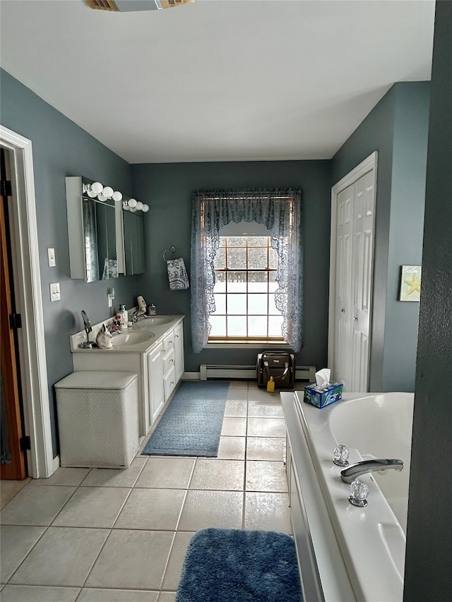 bathroom with tile patterned flooring, a bathing tub, vanity, and a baseboard radiator