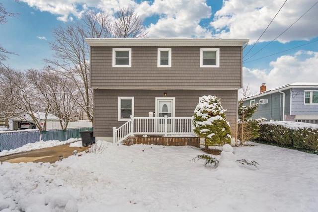 view of snow covered back of property