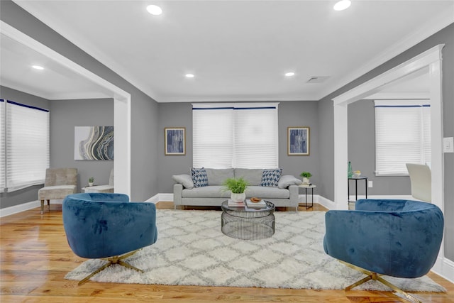 living room with ornamental molding and hardwood / wood-style floors