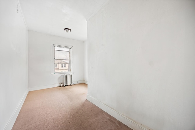 carpeted spare room with radiator heating unit and baseboards