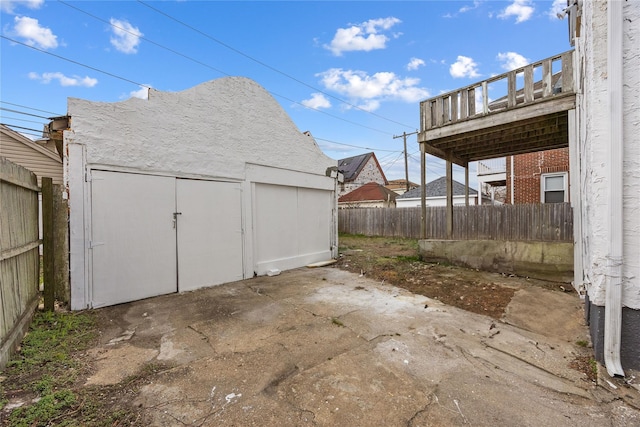 exterior space featuring an outdoor structure, fence, and a patio