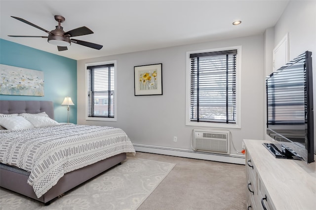 carpeted bedroom featuring ceiling fan, a baseboard radiator, and a wall mounted air conditioner