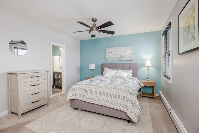 carpeted bedroom with a baseboard heating unit, ceiling fan, and ensuite bathroom