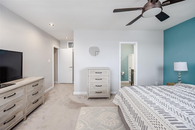 carpeted bedroom featuring ensuite bath and ceiling fan