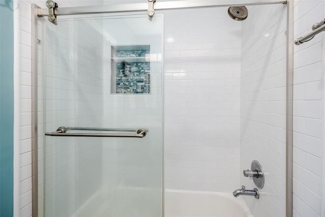 bathroom featuring bath / shower combo with glass door