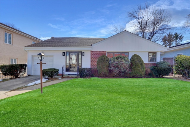 single story home with a garage and a front lawn