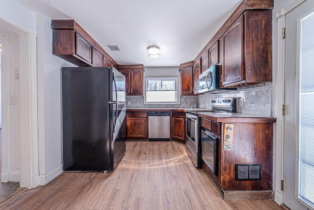 6 Mcgill Rd, Monroe, NY 10950 - kitchen with tasteful backsplash, appliances with stainless steel finishes, sink, and light hardwood / wood-style flooring