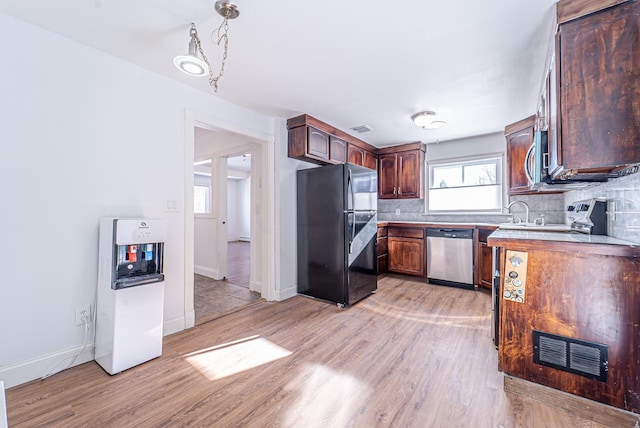 6 Mcgill Rd, Monroe, NY 10950 - kitchen featuring stainless steel appliances, decorative light fixtures, light wood-type flooring, and backsplash