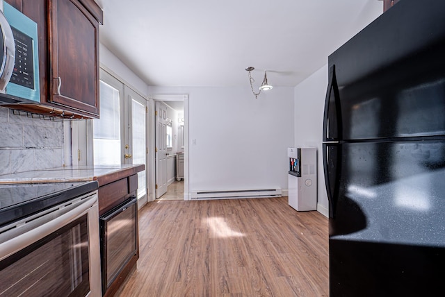 6 Mcgill Rd, Monroe, NY 10950 - kitchen featuring dark brown cabinets, light hardwood / wood-style flooring, baseboard heating, stainless steel appliances, and decorative backsplash