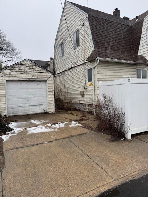 view of property exterior with an outbuilding and a garage