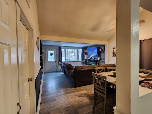 interior space with dark hardwood / wood-style flooring and lofted ceiling