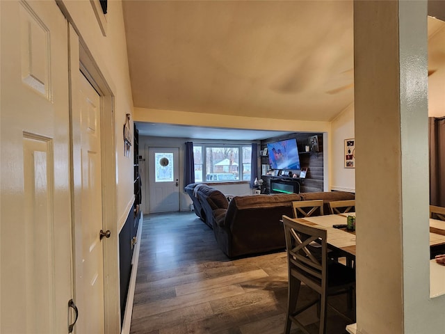 interior space featuring lofted ceiling and dark wood-type flooring