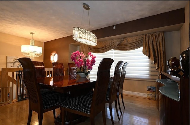 dining room featuring a notable chandelier and wood-type flooring