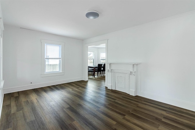 spare room featuring ornamental molding and dark hardwood / wood-style floors