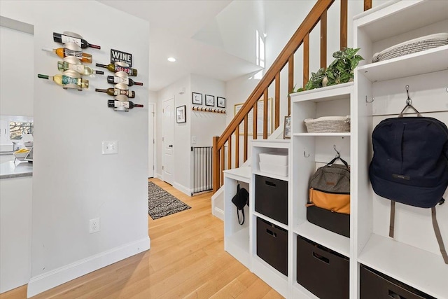 mudroom with light wood-type flooring, baseboards, and recessed lighting