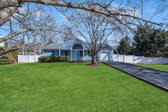 ranch-style home featuring a garage and a front lawn