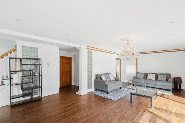 living room featuring decorative columns, baseboards, stairway, dark wood-type flooring, and crown molding