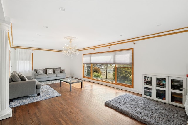 living area featuring a chandelier, wood finished floors, and crown molding