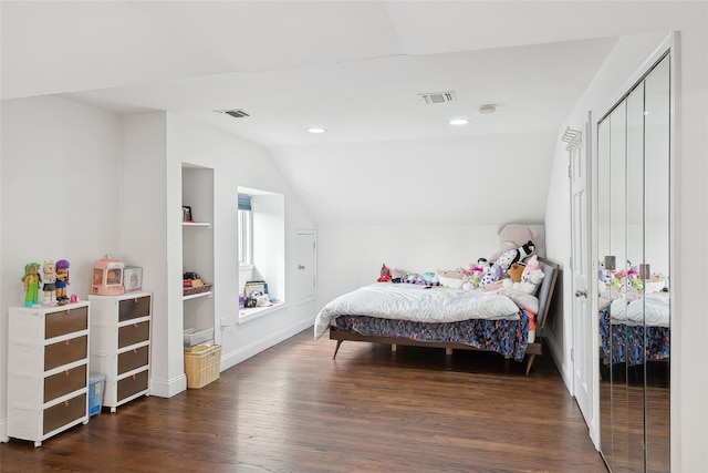 bedroom featuring lofted ceiling, visible vents, dark wood-type flooring, and recessed lighting