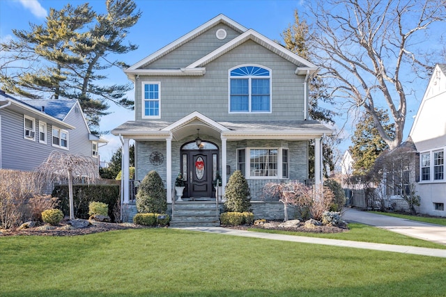 view of front facade with a front yard and fence