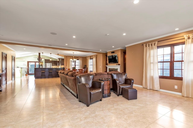 living room with recessed lighting, a fireplace, crown molding, and baseboards