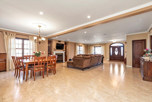 dining space with baseboards, a fireplace with flush hearth, crown molding, a notable chandelier, and recessed lighting