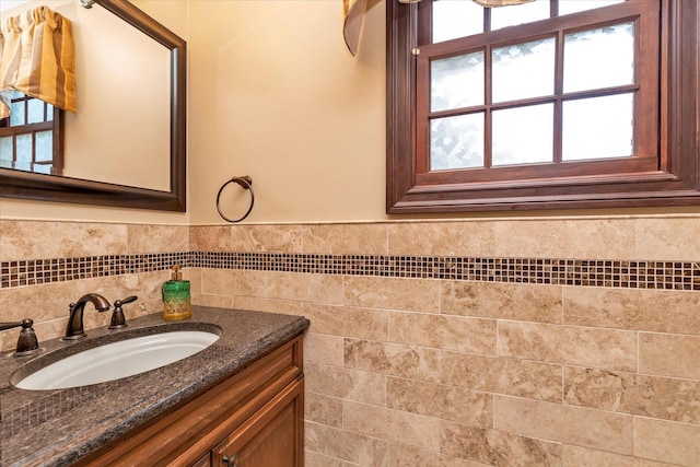 bathroom featuring a wainscoted wall, tile walls, and vanity