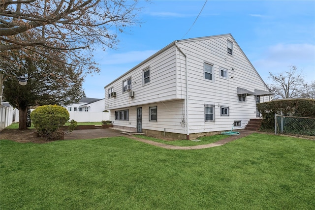 back of property featuring a lawn, a patio area, and a fenced backyard