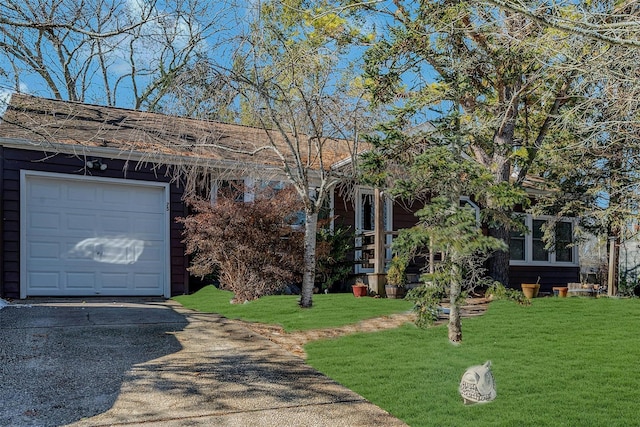 single story home featuring a garage and a front yard