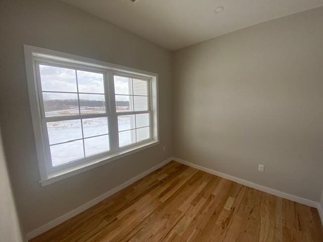 spare room featuring light hardwood / wood-style flooring