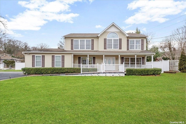 view of front of home with a front yard and covered porch