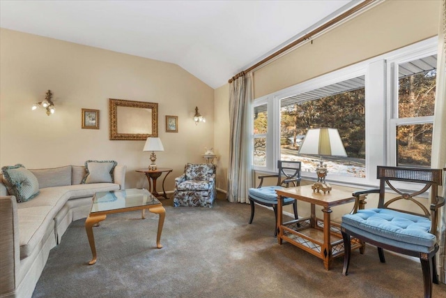 sitting room featuring carpet flooring and vaulted ceiling