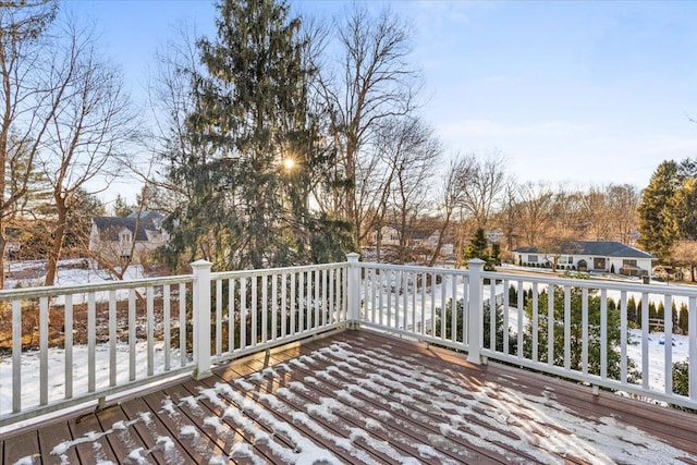 snow covered deck featuring a residential view