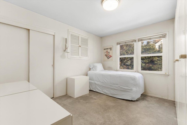 bedroom featuring a closet and light colored carpet