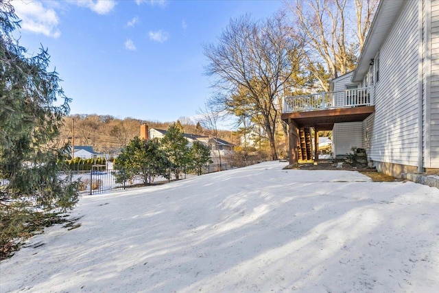 view of yard featuring fence, a wooden deck, and a residential view