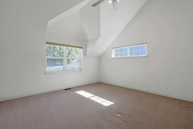 bonus room with carpet floors, lofted ceiling, visible vents, and baseboards