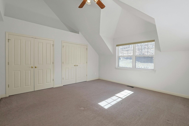 bonus room with carpet floors, baseboards, and vaulted ceiling