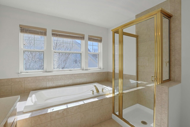 full bath featuring a garden tub and a shower stall