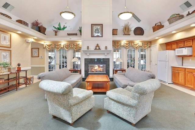 living room with light carpet, visible vents, high vaulted ceiling, and french doors