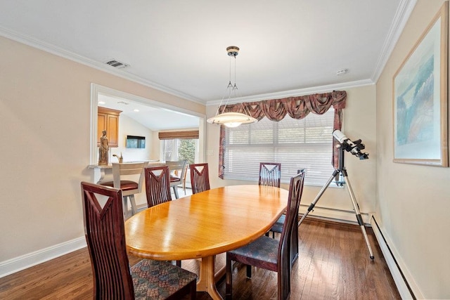 dining room featuring baseboards, lofted ceiling, hardwood / wood-style floors, crown molding, and a baseboard heating unit