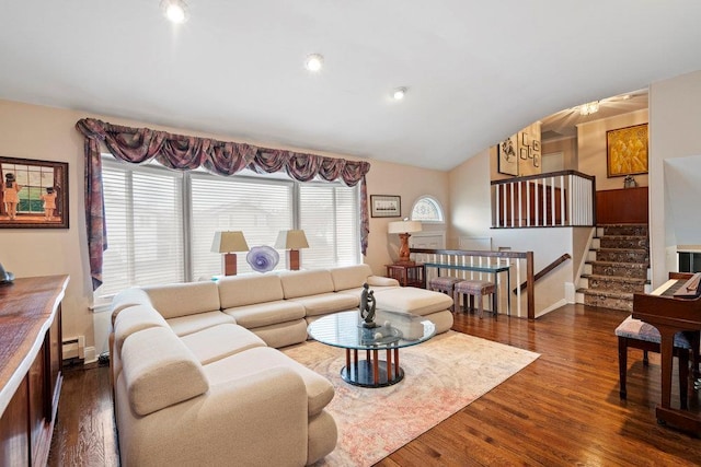 living room with wood finished floors, vaulted ceiling, baseboards, and stairs