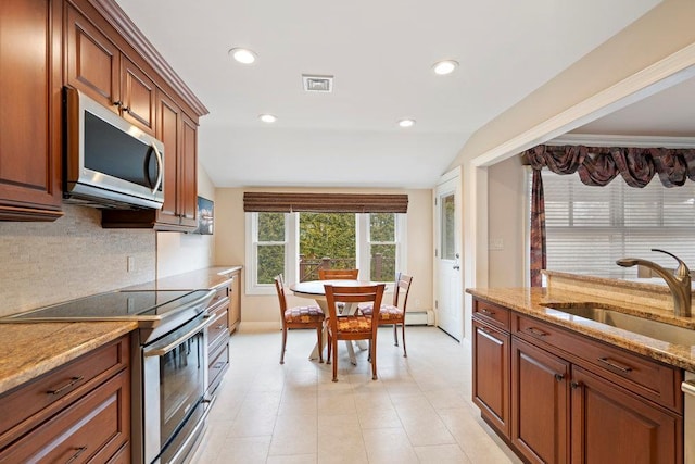 kitchen with stainless steel appliances, a sink, visible vents, light stone countertops, and tasteful backsplash