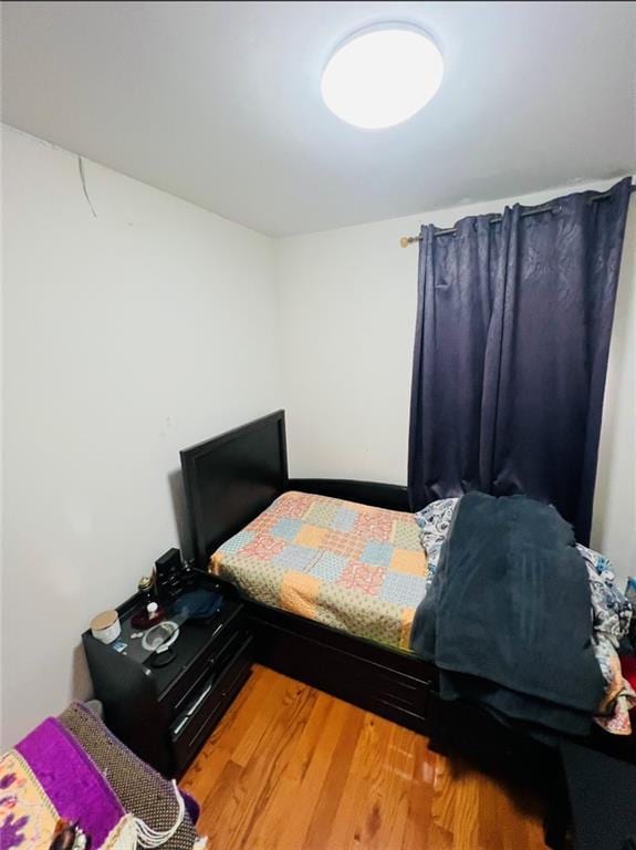 bedroom with hardwood / wood-style floors