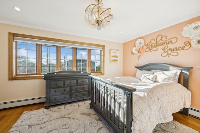 bedroom featuring crown molding, multiple windows, and wood finished floors