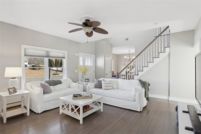 living room with dark wood-style floors, stairway, and a wealth of natural light